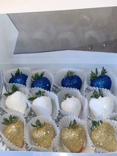 a box filled with chocolate covered strawberries on top of a white countertop next to blue and gold decorations