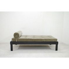 a mattress sitting on top of a wooden frame