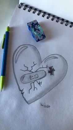 a pencil drawing of a heart with a face on it next to a rubber stamp