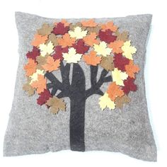 a gray pillow with an autumn tree on it