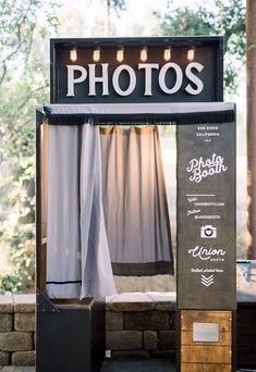 an outdoor photo booth with curtains and lights