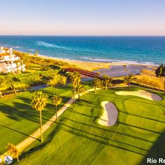 an aerial view of the golf course and ocean