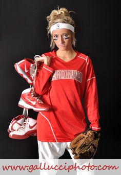 a woman in red shirt holding baseball gloves