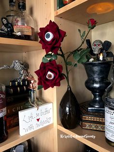 the shelves are filled with liquor bottles and fake flowers in vases on top of them