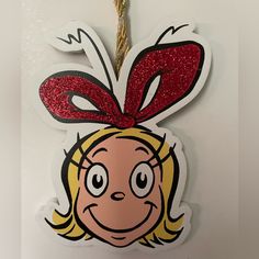 Cover Your Christmas In Smiling Faces Straight From The Imagination Of Dr. Seuss! It's Easy To Get Started With This New Grinch Cindy Lou Who Ornament. This Ornament Is Shaped Like Cindy Lou Who's Face With A Red Glitter Bow. Use The Twisted Rope At The Top To Hang It By The Highest Branch! Details: Length: 4 3/4" Width: 3 1/2" Thickness: 1/8" Cindy Lou Who Ornament, Grinch Cindy Lou, Teaching Classroom Decor, Grinch Ornament, Grinch Ornaments, Heart Christmas Ornaments, Grinch Face, Rudolph Christmas, Cindy Lou Who