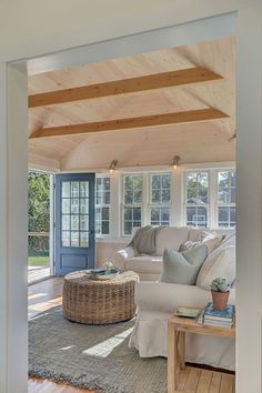 a living room filled with furniture and a blue door leading to a covered patio area