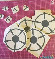 cut out pieces of paper with black and white circles on them next to some scissors