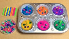 a muffin tin filled with lots of colorful sprinkles