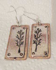 These silver plated (treated to deter tarnish) 3-D earrings are approximately 1 1/4 inch in length and 5/8 inch wide.  They are backed with gold plate, in the style of slightly distressed and the back of these earrings are plain.  All earrings have sterling silver (.925) fishhook fasteners and all fishhooks come with a clear, rubber earring back. Stamped Metal Earrings For Gifts, Nickel-free Rectangular Metal Earrings, Vintage Rectangular Metal Earrings, Nickel-free Brass Rectangular Earrings, Nickel-free Rectangular Brass Earrings, Fish Hook, Earring Backs, Silver 925, Jewelry Earrings Dangle