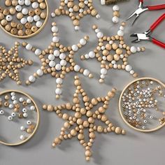 wooden bead snowflakes and other crafting supplies are arranged on a table