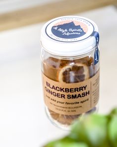 a jar of black berry ginger smash sitting on a counter