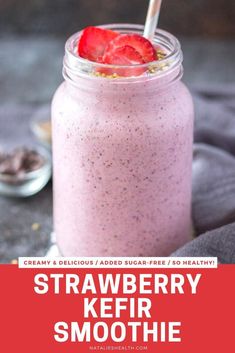 strawberry smoothie in a mason jar with strawberries on top