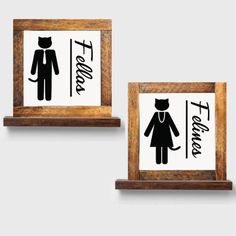 two wooden framed signs with black and white images on them, one has a cat and the other is a woman