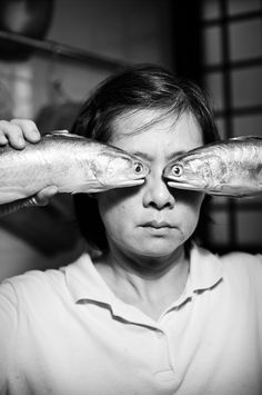 a woman looking through the eyes of another person with fish in front of her face