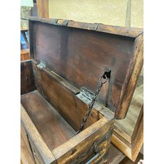 an old wooden chest with chains hanging from it's sides and the lid open