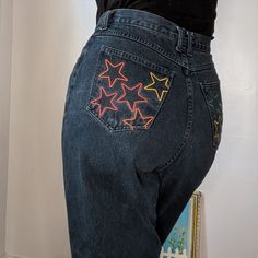 "Sensible Slacks Original Reworked Rainbow Star Jeans. A pair of vintage dark wash high rise Crossroads jeans reworked (by me!) with embroidered rainbow stars on the rear pockets. Jeans are 100% cotton, made in Mexico. Marked a size 14 Relaxed- 32\" waist, 13 \" rise, 43\" hips, 30\" inseam, 14\" leg opening. In great vintage condition with a mended spot at the front belt loop and some worn and mended spots in the inner pockets." Star Pocket Jeans, Embroidered Rainbow, Rainbow Stars, Rainbow Star, Star Jeans, Womens Jeans, Fall Street Style, Pocket Jeans, Street Style Women