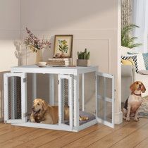 two dogs are sitting in their kennels on the floor next to each other