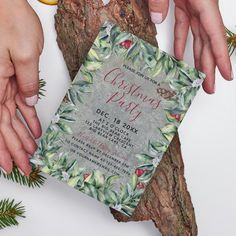 two hands reaching for an orange on top of a piece of wood with the words christmas party next to it