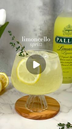 a glass filled with lemonade sitting on top of a table