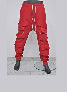 "XS - 8XL New Assasin Men Cotton Fleece Relaxed Belted Flap Zip Sarrouel Joggers, Drop-Crotch Trousers, Soft and Comfy Handmade Plus size, Webbing Ninja -BB300 Futuristic Clothing,techwear style -*-- *The waist can be adjusted for expansion and contraction using the built-in elastic and drawcord. ・The cargo part uses EXCELLA ZIP from YKK. * Material : French Terry + Diagonal * Model wears : XLarge  * Picture colour : Red& GRAY Fit True to Size - So pick up your actual size. All our products are Fitted Winter Cargo Pants With Side Pockets, Red Sweatpants With Pockets For Fall, Hip Hop Style Sweatpants With Pockets, Fitted Sweatpants With Pockets For Winter, Fitted Winter Sweatpants With Pockets, Tech Ninja, Futuristic Clothing, Colour Red, Cotton Fleece