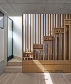 an empty room with wooden stairs and shelves