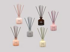 six bottles filled with different types of reed diffusers and sticks, all in various colors