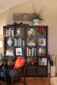 a living room filled with furniture and bookshelves covered in lots of different types of items