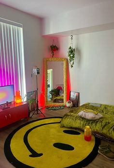 a bedroom with a smiley face rug on the floor and a television in the corner