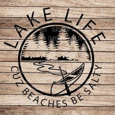 a wooden sign with the words lake life on it and a boat in the water