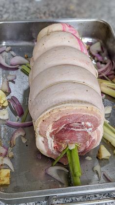 a metal tray filled with meat and veggies