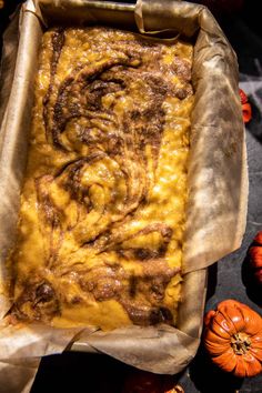 a casserole in a pan with pumpkins around it