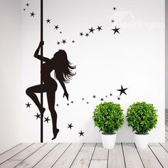 a wall sticker with a woman on a pole and stars in the background,