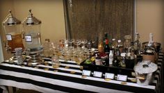 a table topped with lots of bottles and glasses