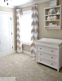 a baby's room with a crib and dresser