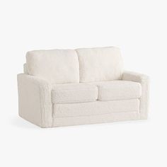 a white couch sitting on top of a white floor