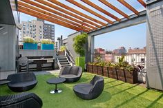 an outdoor living area with grass and furniture