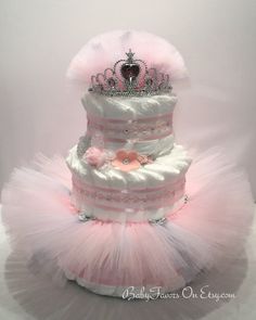 a pink and white diaper cake with a tiara on top