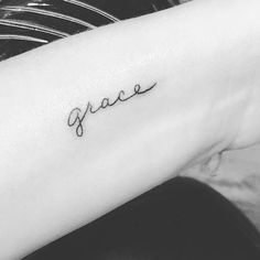 a woman's arm with the word grace written in cursive font on it