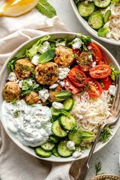 two bowls filled with different types of food and garnished with herbs, sitting next to each other