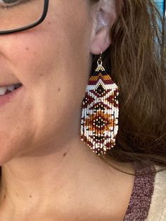 Brown Dangle Beaded Earrings With Tiny Beads, Traditional Brown Handwoven Beaded Earrings, Traditional Brown Beaded Earrings With Tiny Beads, Brown Beaded Earrings With Fringe, Brown Fringe Dangle Beaded Earrings, Brown Beaded Fringe Dangle Earrings, Brown Handwoven Beaded Drop Earrings, Artisan Beaded Earrings With Fringe, Brown Dangle Beaded Earrings With Fringe