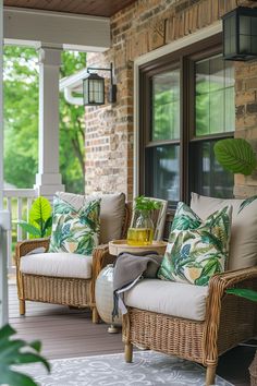 a porch with wicker furniture and pillows on it