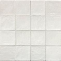 a white tile wall with square tiles on it