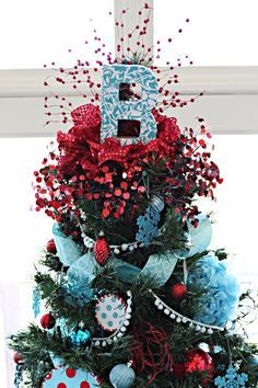 a christmas tree decorated with red, white and blue ornaments