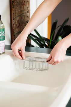 a person is cleaning a sink with hand sanitizer