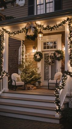 the front porch is decorated with christmas lights and wreaths