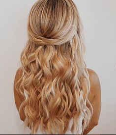 the back of a woman's head with long blonde hair