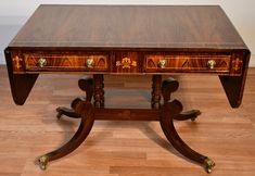 a wooden desk with two drawers on one end and an ornate design on the other