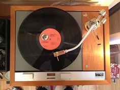 an old record player is on display in a cabinet