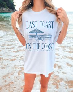 a woman standing on the beach wearing a t - shirt that says last toast on the coast