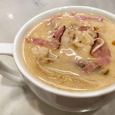 a white bowl filled with soup on top of a table